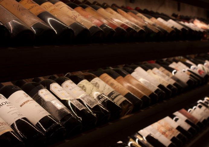 bottles of wine laid in a shelf