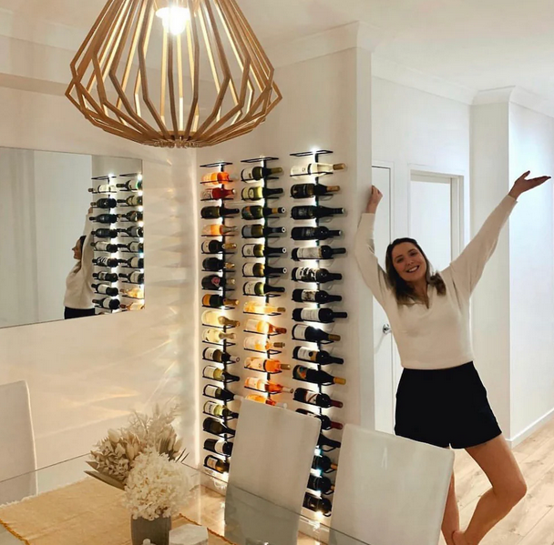 a lady dancing, a wine rack and a lamp on the room