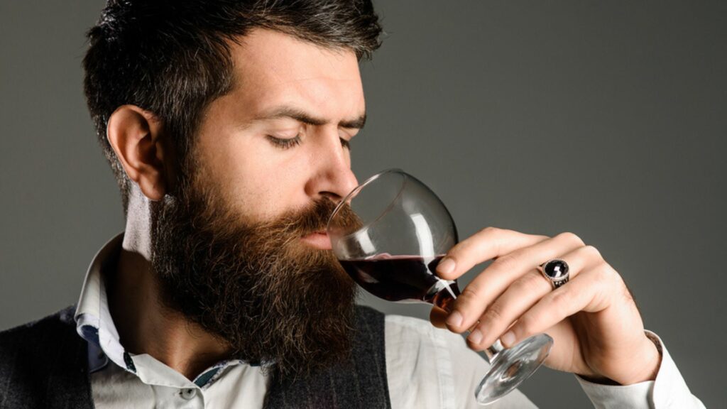 a man drinking wine showing the benefits of drinking wine 