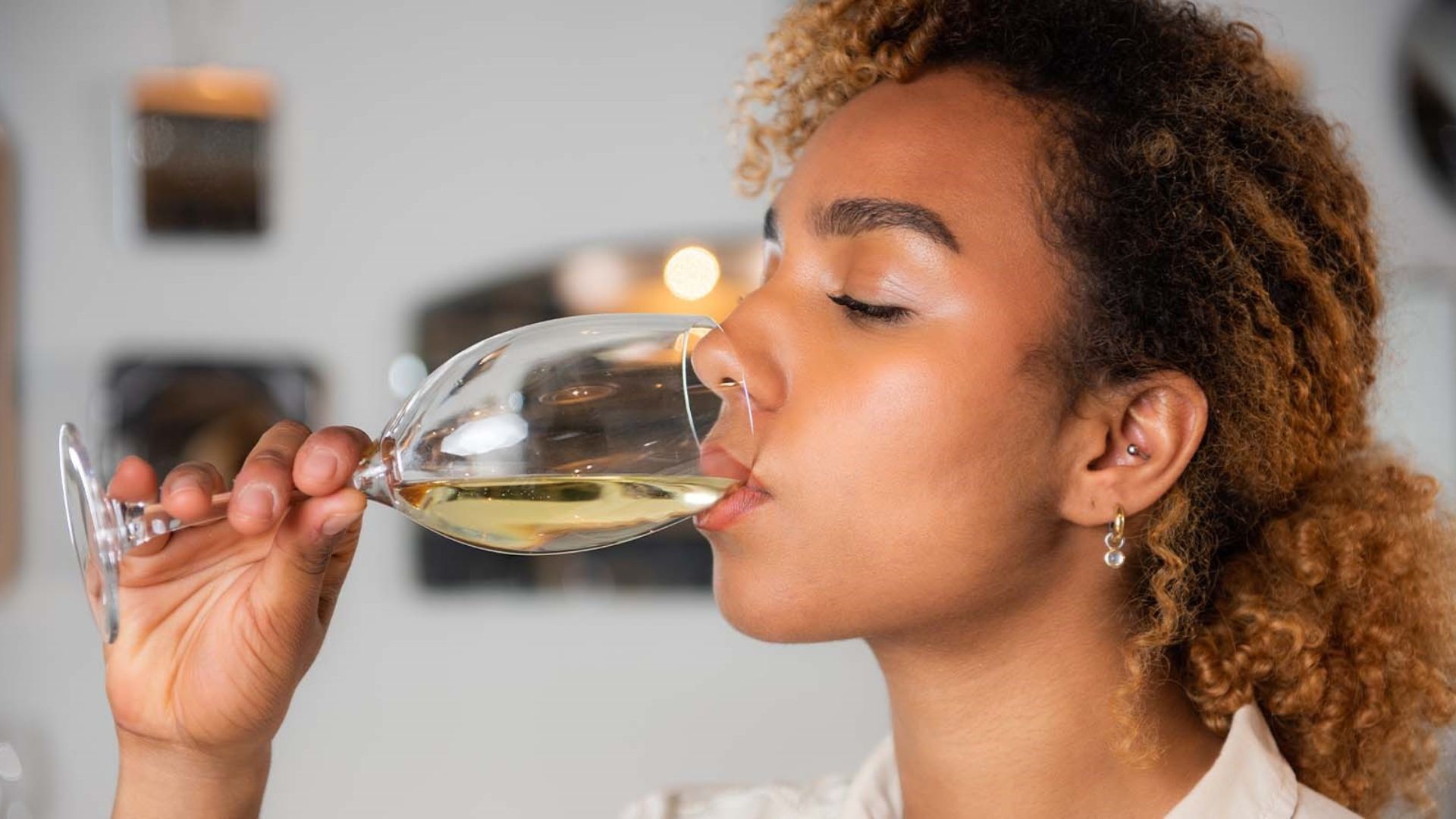 a lady drinking wine showing the basic wine taste
